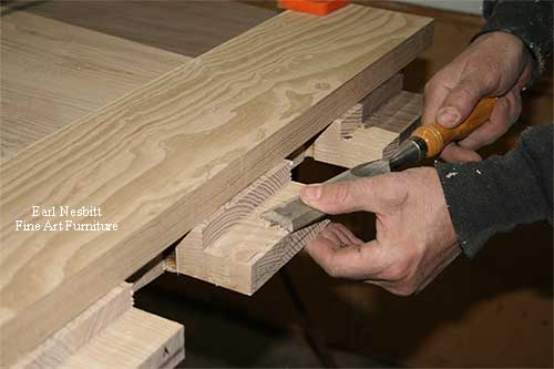 close up on Earl chiseling tenons on one end of custom made dining table